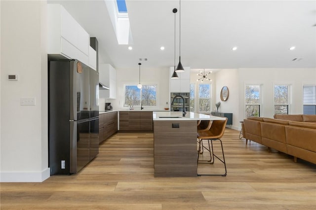 kitchen with modern cabinets, open floor plan, appliances with stainless steel finishes, and light countertops