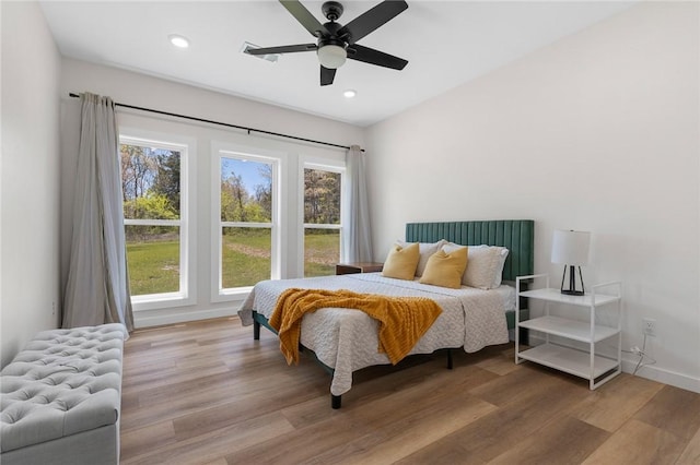 bedroom featuring recessed lighting, wood finished floors, a ceiling fan, and baseboards