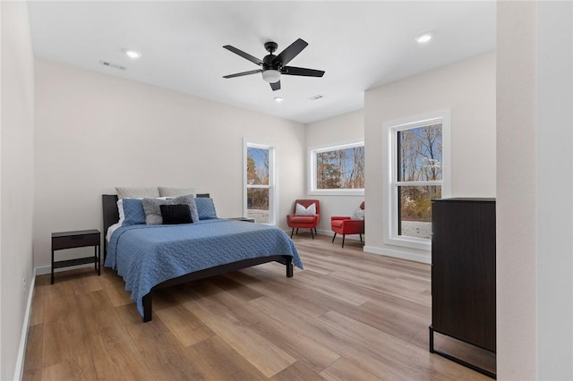bedroom featuring light wood finished floors, baseboards, visible vents, recessed lighting, and a ceiling fan