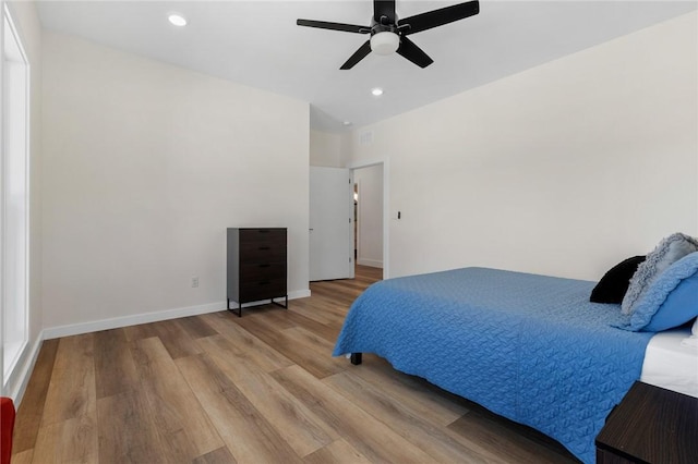 bedroom featuring ceiling fan, baseboards, wood finished floors, and recessed lighting