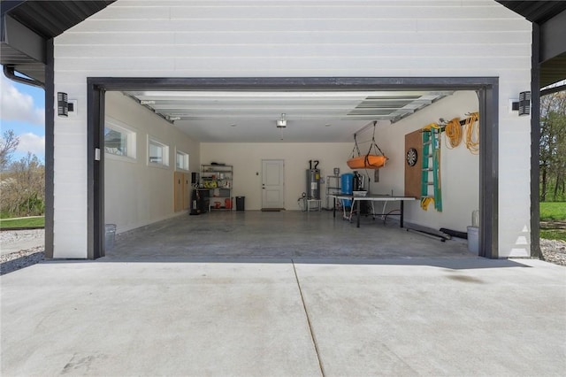 garage featuring water heater and concrete driveway