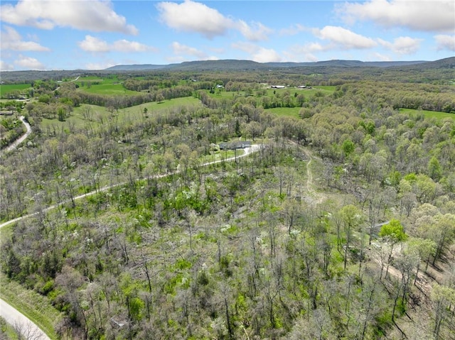 birds eye view of property with a view of trees