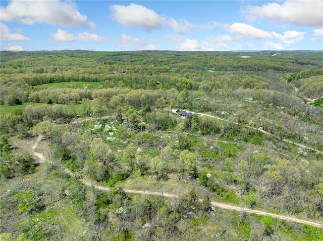 drone / aerial view featuring a wooded view