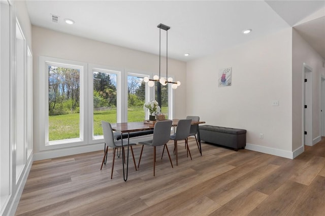 dining area with an inviting chandelier, light wood-style flooring, baseboards, visible vents, and recessed lighting