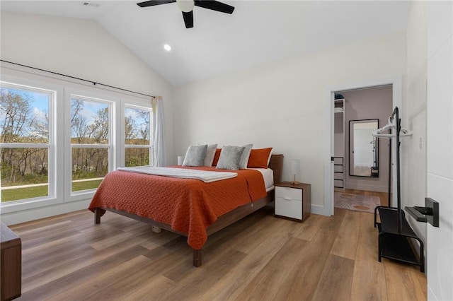 bedroom with vaulted ceiling, light wood-style floors, ceiling fan, baseboards, and recessed lighting