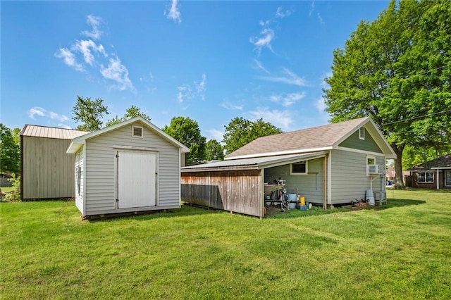 511 N Oakwood St, Lowell, AR 72745 - back of property with a lawn, an outdoor structure, and a shed