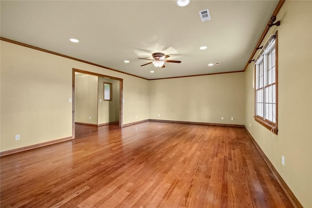 511 N Oakwood St, Lowell, AR 72745 - spare room featuring a ceiling fan, baseboards, ornamental molding, recessed lighting, and light wood-style flooring