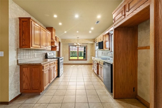 511 N Oakwood St, Lowell, AR 72745 - kitchen with dishwasher, premium range hood, a chandelier, backsplash, and gas stove