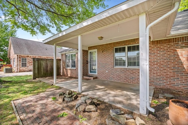 511 N Oakwood St, Lowell, AR 72745 - view of patio featuring central AC and fence