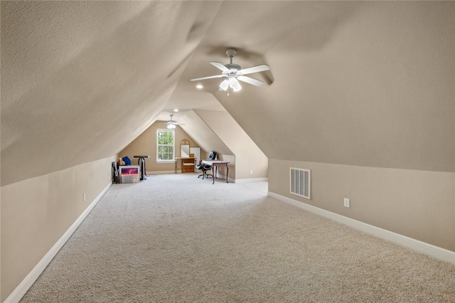 additional living space featuring vaulted ceiling, visible vents, baseboards, and carpet
