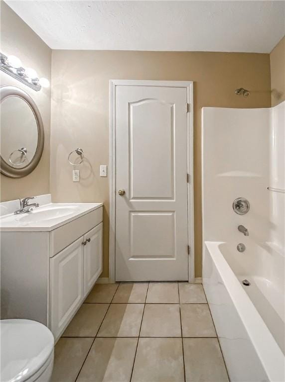 bathroom featuring shower / bathtub combination, vanity, tile patterned flooring, and toilet