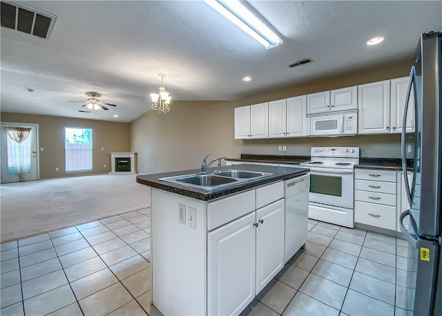 kitchen with white cabinets, visible vents, a sink, and white appliances