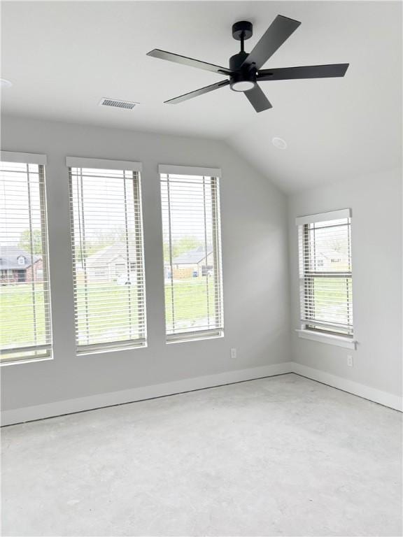 empty room featuring concrete flooring, visible vents, a ceiling fan, and baseboards