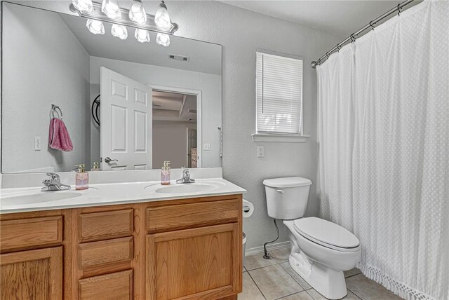 bathroom with tile patterned flooring, double vanity, visible vents, toilet, and a sink