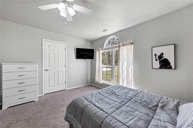 bedroom with baseboards, a ceiling fan, visible vents, and carpet