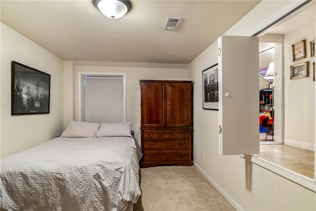 bedroom featuring baseboards, visible vents, and light colored carpet