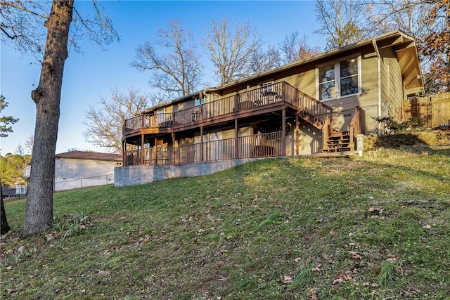 back of property featuring a lawn, stairs, fence, and a deck