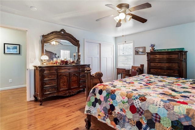 bedroom with ceiling fan, baseboards, light wood-style floors, and a closet