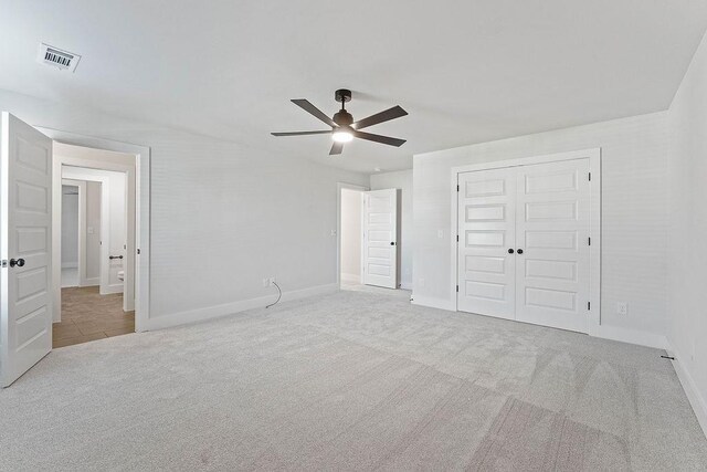 6416 S 59th St, Rogers, AR 72758 - unfurnished bedroom featuring carpet flooring, a closet, and a ceiling fan