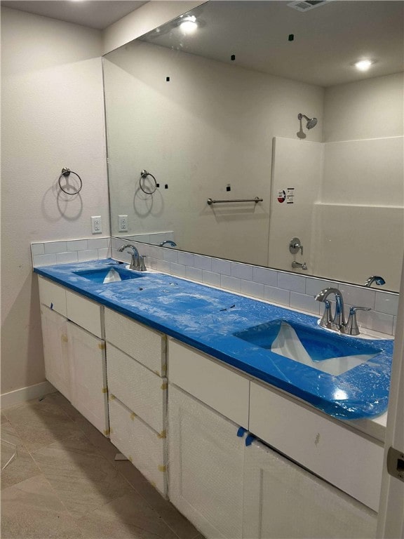 34 Brierfield Ln, Bella Vista, AR 72714 - full bathroom with double vanity, a shower, and backsplash