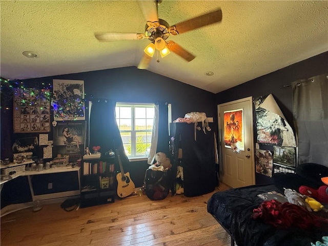 1306 Sunset Blvd, Berryville, AR 72616 - bedroom featuring hardwood / wood-style floors, vaulted ceiling, a textured ceiling, and a ceiling fan