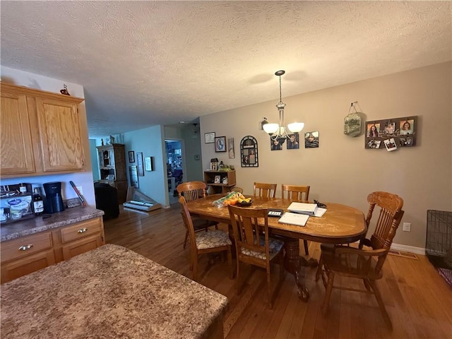 1306 Sunset Blvd, Berryville, AR 72616 - dining space with a chandelier, a textured ceiling, and dark wood-style flooring