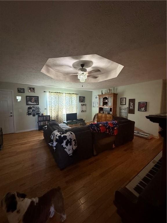 1306 Sunset Blvd, Berryville, AR 72616 - living room featuring a raised ceiling, wood finished floors, and baseboards
