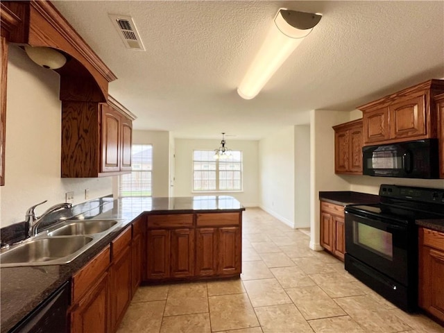 1650 Affirmed Ln, Prairie Grove, AR 72753 - kitchen with black appliances, dark countertops, a peninsula, a textured ceiling, and brown cabinets