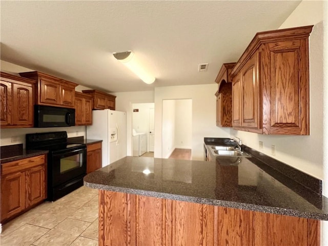 1650 Affirmed Ln, Prairie Grove, AR 72753 - kitchen featuring black appliances, a peninsula, and brown cabinets