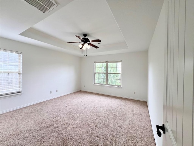 1650 Affirmed Ln, Prairie Grove, AR 72753 - spare room featuring a tray ceiling, carpet flooring, and a ceiling fan