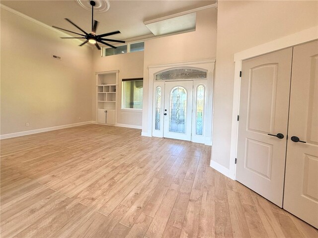 14689 Frisco Springs Rd, Lowell, AR 72745 - entryway with a towering ceiling, light wood-type flooring, ceiling fan, and baseboards