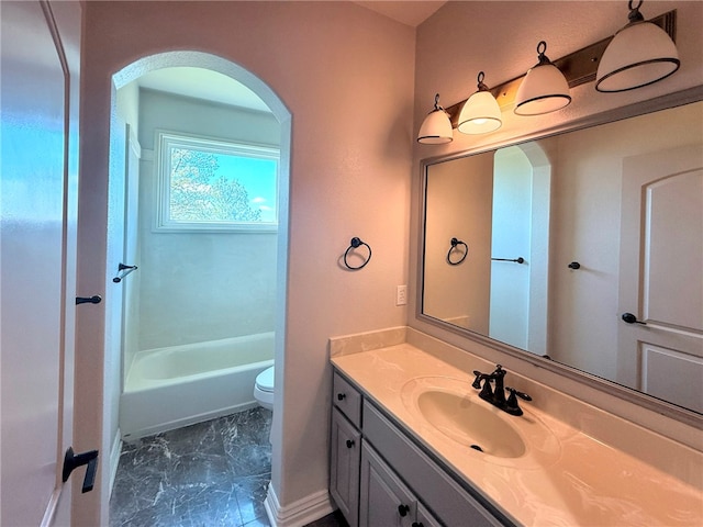 full bathroom with a washtub, a shower, vanity, toilet, and marble finish floor