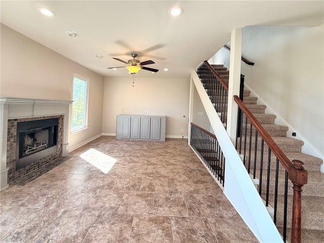 14689 Frisco Springs Rd, Lowell, AR 72745 - unfurnished living room featuring a ceiling fan, stairs, recessed lighting, a tiled fireplace, and baseboards