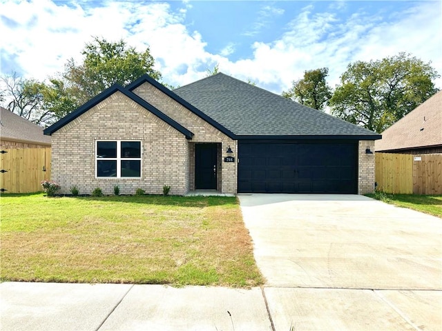 708 W Taylor St, Siloam Springs, AR 72761 - view of front of property with fence, driveway, brick siding, and a front yard