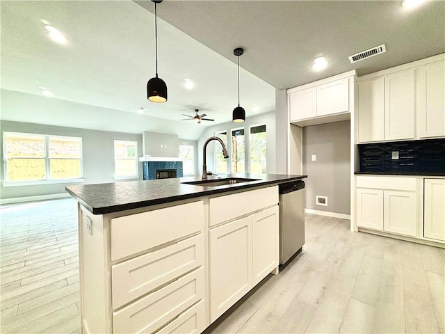 708 W Taylor St, Siloam Springs, AR 72761 - kitchen with stainless steel dishwasher, dark countertops, a sink, and recessed lighting