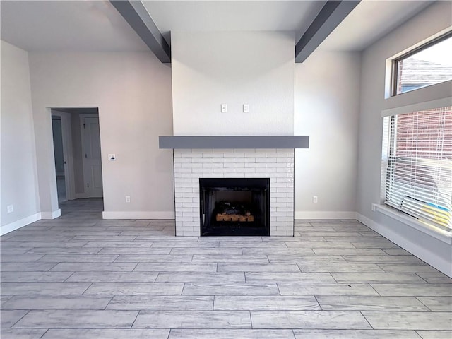 interior details with baseboards, wood finished floors, and beamed ceiling