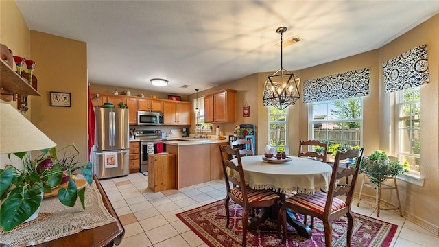 dining area with a chandelier, visible vents, baseboards, and light tile patterned floors