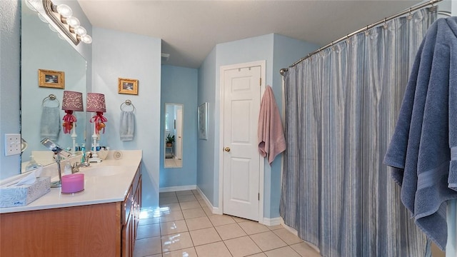 full bathroom featuring tile patterned floors, baseboards, and vanity