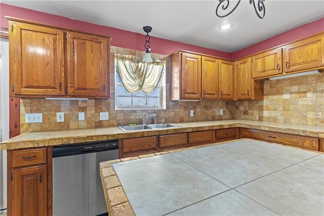 kitchen featuring light countertops, a sink, decorative backsplash, brown cabinets, and dishwasher