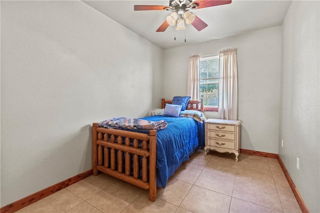 bedroom featuring a ceiling fan, baseboards, and light tile patterned flooring