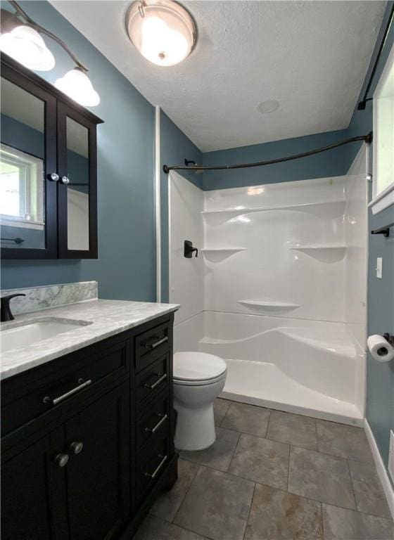 4802 Greenbriar Ln, Everton, AR 72633 - bathroom featuring a textured ceiling, vanity, walk in shower, baseboards, and toilet