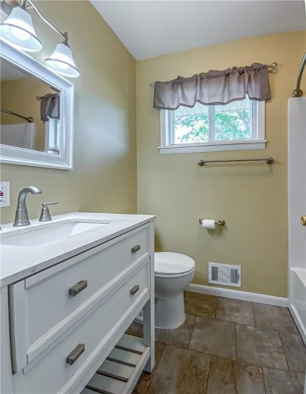 4802 Greenbriar Ln, Everton, AR 72633 - bathroom with  shower combination, toilet, baseboards, visible vents, and vanity