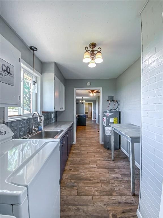 4802 Greenbriar Ln, Everton, AR 72633 - kitchen with a sink, dark wood-style flooring, a ceiling fan, pendant lighting, and water heater