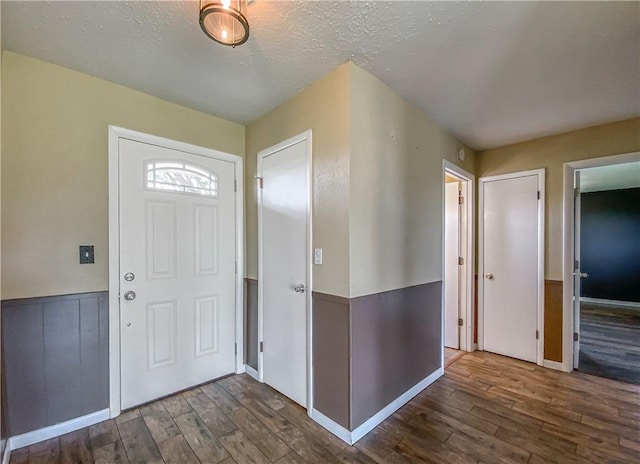 4802 Greenbriar Ln, Everton, AR 72633 - foyer entrance featuring wood finished floors and a textured ceiling