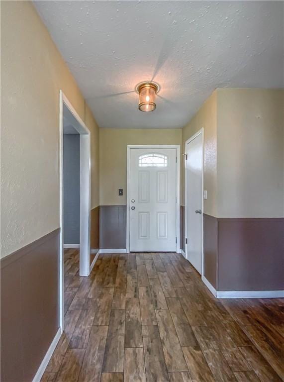 4802 Greenbriar Ln, Everton, AR 72633 - foyer with a textured ceiling, hardwood / wood-style flooring, and wainscoting