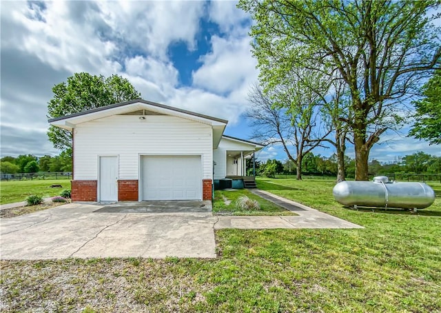 4802 Greenbriar Ln, Everton, AR 72633 - view of home's exterior with brick siding, a lawn, concrete driveway, and fence