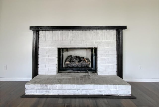 4802 Greenbriar Ln, Everton, AR 72633 - interior details with baseboards, a brick fireplace, and wood finished floors