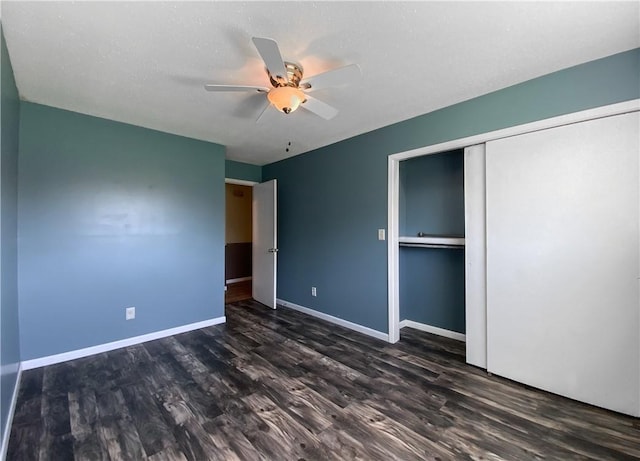 4802 Greenbriar Ln, Everton, AR 72633 - unfurnished bedroom with a ceiling fan, baseboards, a closet, and dark wood finished floors