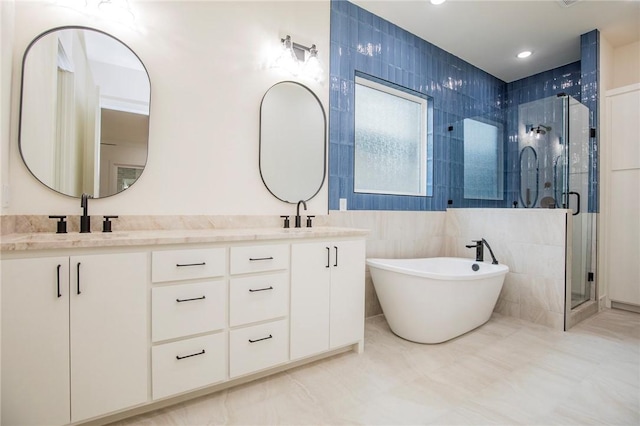 4708 Fieldcrest Ter, Rogers, AR 72758 - bathroom featuring a shower stall, double vanity, a freestanding bath, and tile walls