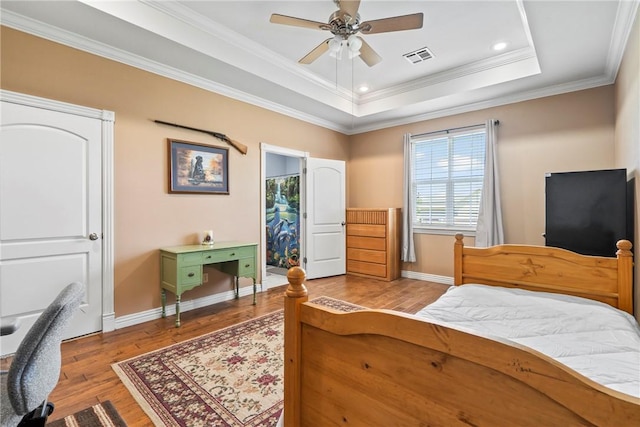 17444 16th Hwy, Siloam Springs, AR 72761 - bedroom featuring wood finished floors, baseboards, crown molding, a tray ceiling, and recessed lighting